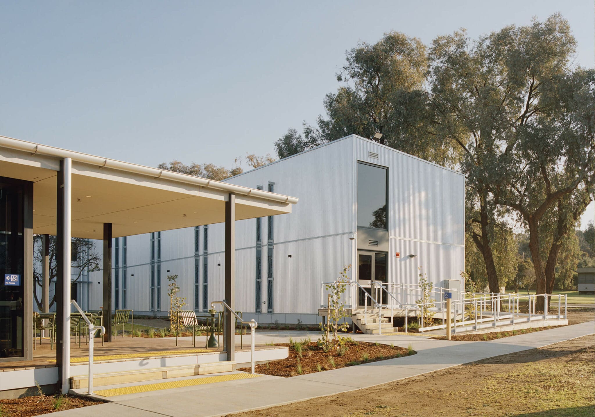 a building with a white building and a walkway